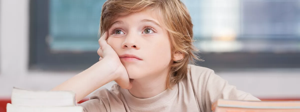 Boy daydreaming while reading