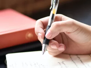 Student hand writing in cursive