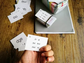 Hand holding phonics flashcards