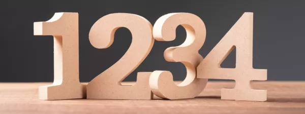 Wood cutouts of the numbers 1, 2, 3, and 4 on a table
