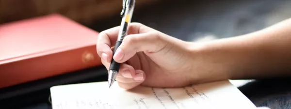 Student hand writing in cursive