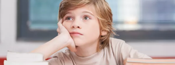 Boy daydreaming while reading