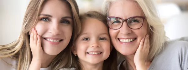 A daughter, mother, and grandmother smiling