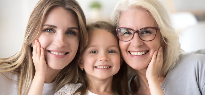 A daughter, mother, and grandmother smiling